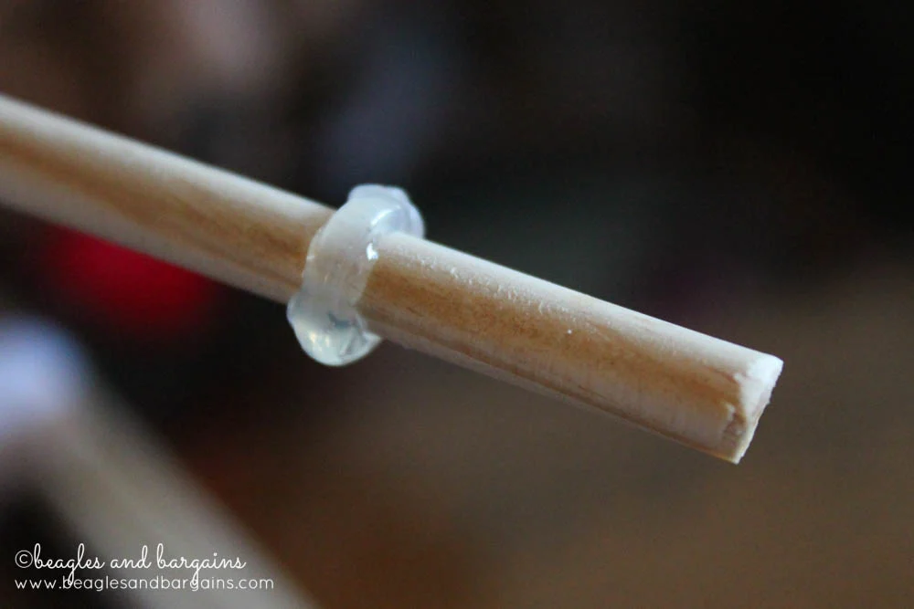 a wood dowel is shown with a ring of hot glue on one end