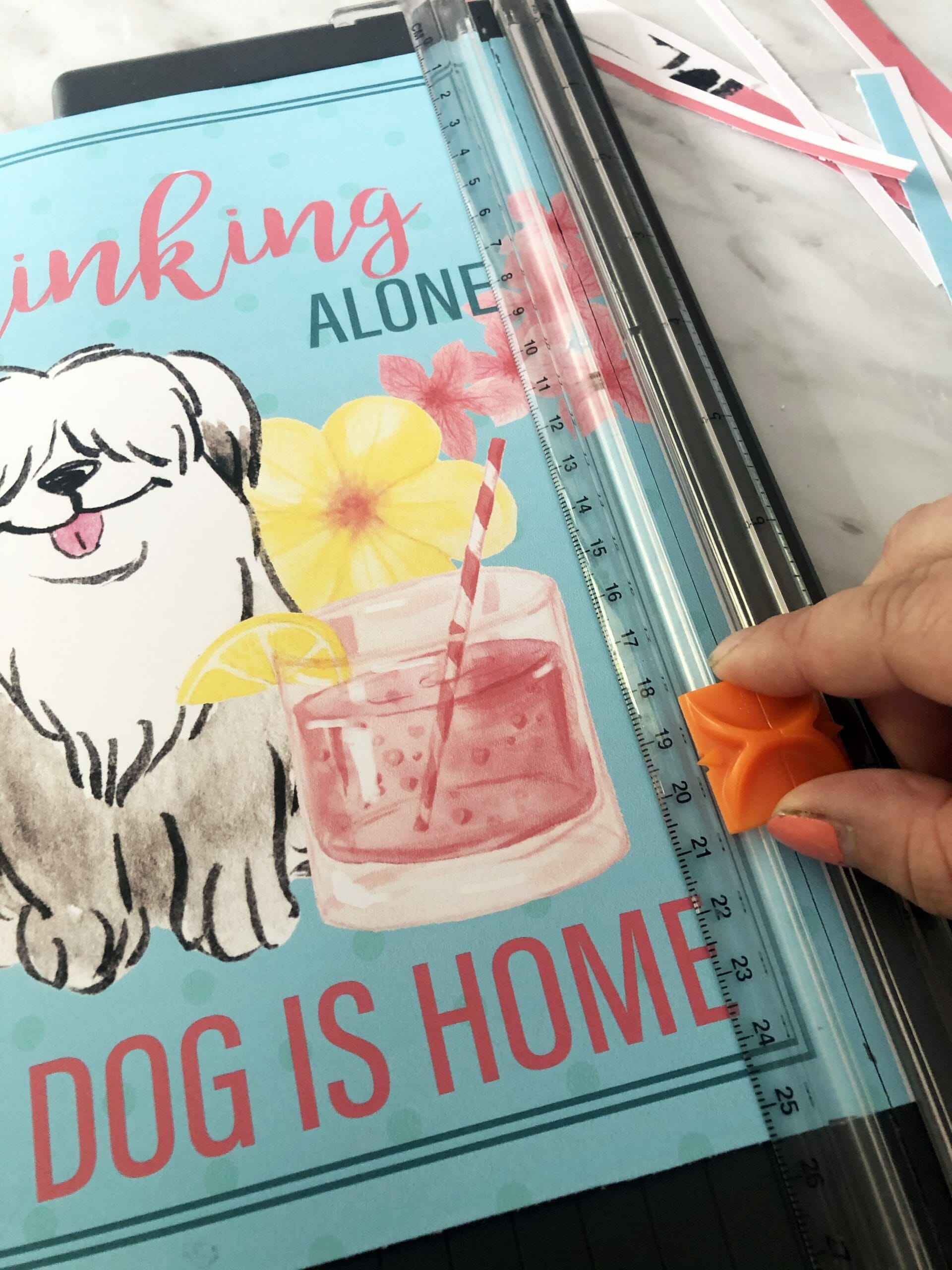 a piece of free printable summer dog art sits on a sliding paper trimmer
