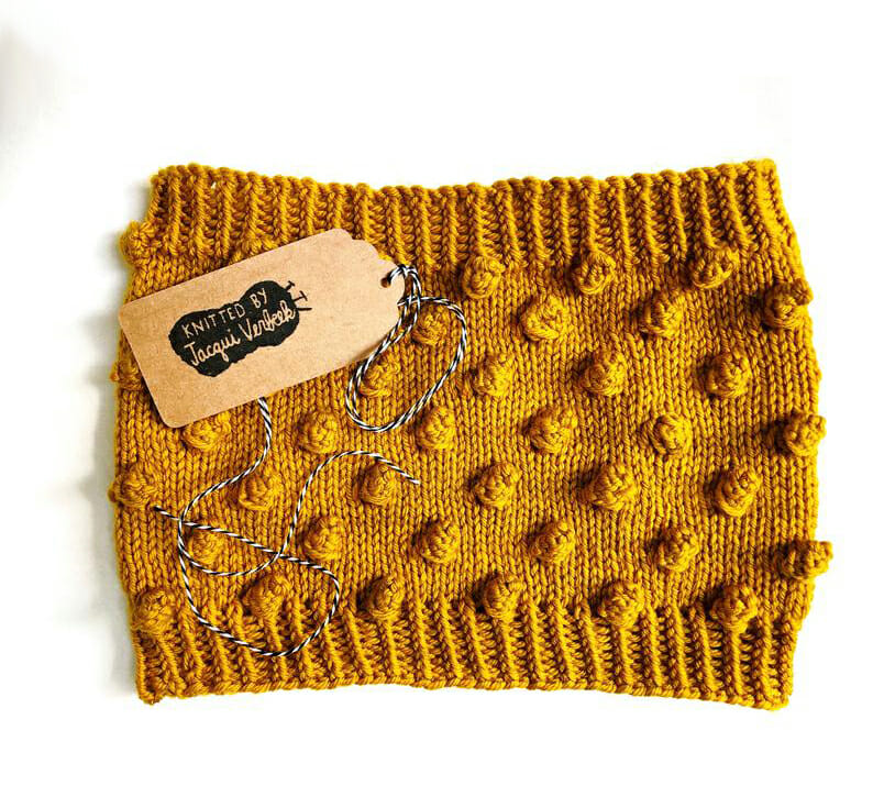 a mustard coloured bobble knit human cowl scarf