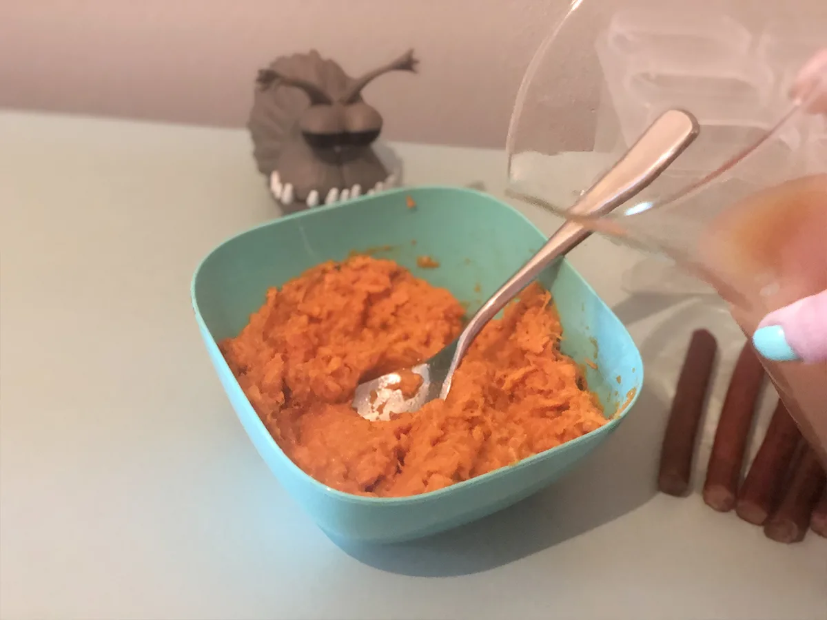 bone broth between poured into a bowl of mashed sweet potato